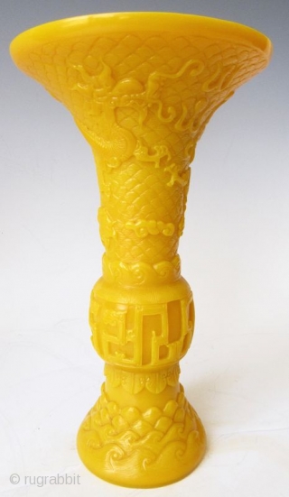 Antique Chinese Pair of Yellow Peking Glass Gu Vases

An elegant pair of Chinese monochrome yellow peking glass gu vases with relief carvings of waves, archaic scrolling serpents, one vase with a pair  ...