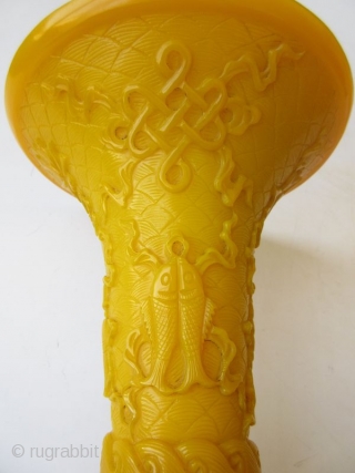 Antique Chinese Pair of Yellow Peking Glass Gu Vases

An elegant pair of Chinese monochrome yellow peking glass gu vases with relief carvings of waves, archaic scrolling serpents, one vase with a pair  ...