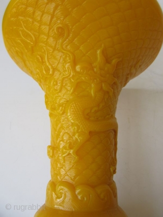 Antique Chinese Pair of Yellow Peking Glass Gu Vases

An elegant pair of Chinese monochrome yellow peking glass gu vases with relief carvings of waves, archaic scrolling serpents, one vase with a pair  ...