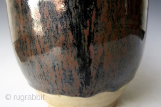 Antique Japanese Tenmoku Ware Handled Vessel


Japanese tenmoku ware ceramic vessel with ribbed handle, short front spout, and wide open top. The thick oil slick glaze stops just short above the foot left  ...