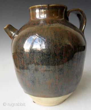 Antique Japanese Tenmoku Ware Handled Vessel


Japanese tenmoku ware ceramic vessel with ribbed handle, short front spout, and wide open top. The thick oil slick glaze stops just short above the foot left  ...