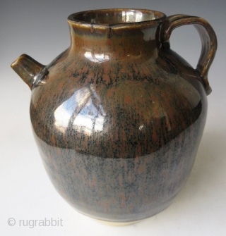 Antique Japanese Tenmoku Ware Handled Vessel


Japanese tenmoku ware ceramic vessel with ribbed handle, short front spout, and wide open top. The thick oil slick glaze stops just short above the foot left  ...