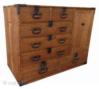 Antique Japanese Small Kiri Tansu

Unusual Japanese Kiri (paulownia) tansu with 8 drawers and a lift away panel opening to a shelved interior with spacious room. The 8 front drawers feature small round  ...