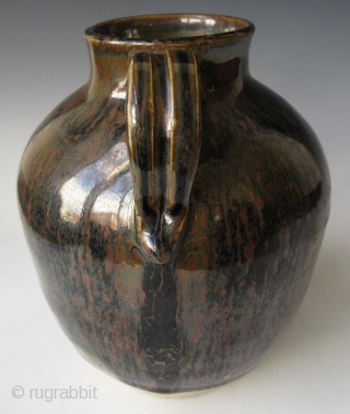 Antique Japanese Tenmoku Ware Handled Vessel


Japanese tenmoku ware ceramic vessel with ribbed handle, short front spout, and wide open top. The thick oil slick glaze stops just short above the foot left  ...