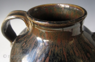 Antique Japanese Tenmoku Ware Handled Vessel


Japanese tenmoku ware ceramic vessel with ribbed handle, short front spout, and wide open top. The thick oil slick glaze stops just short above the foot left  ...