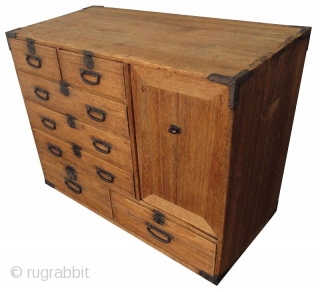 Antique Japanese Small Kiri Tansu

Unusual Japanese Kiri (paulownia) tansu with 8 drawers and a lift away panel opening to a shelved interior with spacious room. The 8 front drawers feature small round  ...
