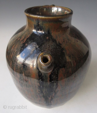 Antique Japanese Tenmoku Ware Handled Vessel


Japanese tenmoku ware ceramic vessel with ribbed handle, short front spout, and wide open top. The thick oil slick glaze stops just short above the foot left  ...