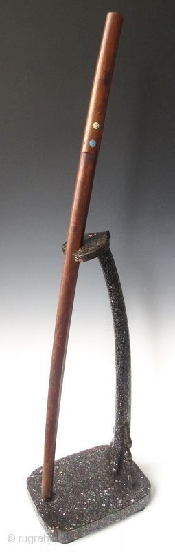 An Unusual Japanese Inlaid Laquer Sword Stand

Japanese tachi-kake or samurai's sword stand, black lacquered and rich intricate shell inlay work, with a reishi mushroom shaped finial. 

Late Edo period (1603-1868) 

Dimensions: 10  ...