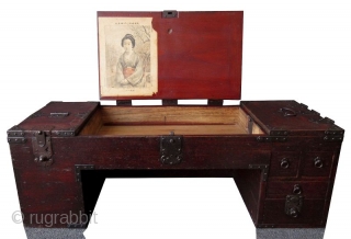 Rare Japanese Low Shop Desk Tansu

Unusual Japanese hardwood low shop desk tansu. Original red lacquer finish with heavy iron plates and mounts. The table surface is hinged with three doors that open  ...