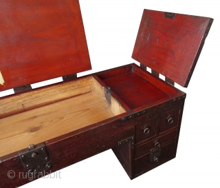 Rare Japanese Low Shop Desk Tansu

Unusual Japanese hardwood low shop desk tansu. Original red lacquer finish with heavy iron plates and mounts. The table surface is hinged with three doors that open  ...