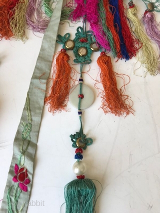 Chinese Embroidered Cloud Collar

A delicate antique Chinese child's collar with stitch work. The fine knitting on the edge is embellished with small white metal discs and multicolored tassels. The shawl collar is  ...