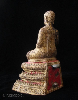 Antique Thai Seated Gilt Bronze Buddha

Gilt bronze Buddha seated with serene expression. Intricate metal granulation on drapery and throne. Details of red lacquer on tiered trapezoidal seat. Thailand. 

Early 19th century 

Dimensions:  ...