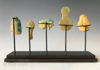 Rare Faience Egyptian Amulets

Five clay faience (blue -green) amulets from Egypt that are mounted on a custom stand. The amulets are a Pharaohs head, a sphinx, a Wedjat eye (Eye of Horus),  ...