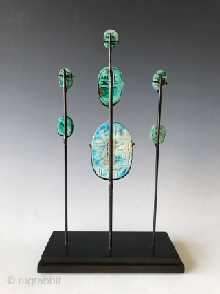 Rare Set of Faience Egyptian Scarab Amulets

Rare faience (blue green glazed) clay Egyptian scarab amulets on a custom stand. Scarabs were popular amulets and impression seals in Ancient Egypt. Egyptian faience is  ...