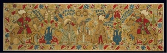 Bridal cushion with wedding scene. From Ioannina in Epiros. It depicts the bride with her parents and the groom with his friend, both on horseback. The riotous floral ornaments, the attractive multi-coloured scenes, and the harmonious execution of the compositions with their distinctly painterly qualities are, from every point of view, characteristic of Epirot embroidery. 17th c. 0.40x1.40 m. Gift of Helen Stathatos. (ΓΕ 21173) image and text copyright Benaki Museum, Athens